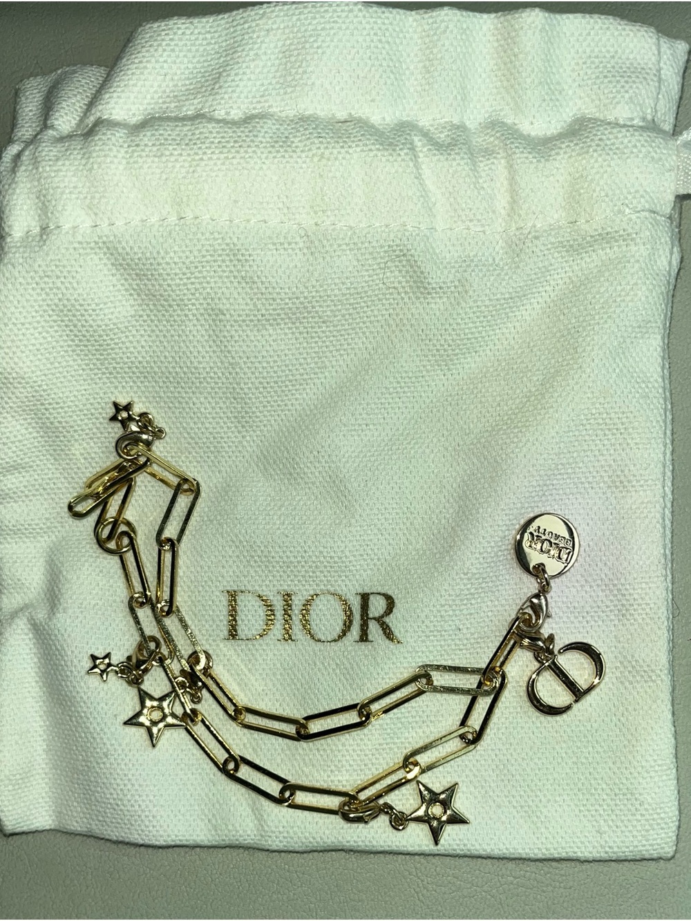 Dior Gold Star Link Phone Charm with Dior jewelry pouch